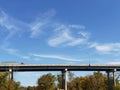 Swirling clouds overlooking bridge Royalty Free Stock Photo