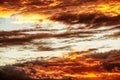 Swirling evening clouds illuminated by the setting sun Royalty Free Stock Photo