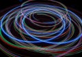 Swirling light trails form overlapping circular patterns against a Royalty Free Stock Photo