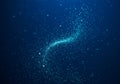 A swirling pattern of small, luminous blue particles set against a deep blue Royalty Free Stock Photo