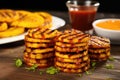 swirls of mango bbq sauce over a stack of grilled plantains