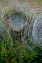 Swirls of metal wires used for farm or garden fencing