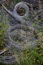 Swirls of metal wires used for farm or garden fencing