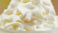 Macro closeup of swirls of whipped cream for cake decorating.