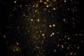 Swirly bokeh of golden glitter shimmer dust abstract background