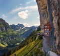 Swiss Alps and a restaurant under a cliff on mountain Ebenalp in Switzerland Royalty Free Stock Photo