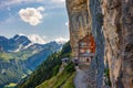 Swiss Alps and a restaurant under a cliff on mountain Ebenalp in Switzerland Royalty Free Stock Photo