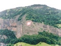 The Swiss alps in the summer swiss flag mounted on a mountain slope Royalty Free Stock Photo