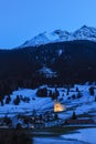 Swiss Alps village Savognin in blue hour time with the catholic church Son Martegn