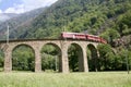 Swiss Bernina express train at the Brusio Circular Viaduct Royalty Free Stock Photo