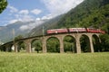 Swiss Bernina express train at the Brusio Circular Viaduct Royalty Free Stock Photo