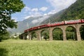 Swiss Bernina express train at the Brusio Circular Viaduct Royalty Free Stock Photo