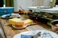 Swiss or Dutch raclette table filled with ingredients for a celebratory evening like Christmas or New Years Eve