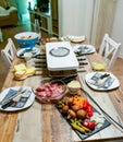 Swiss or Dutch raclette table filled with ingredients for a celebratory evening like Christmas or New Years Eve