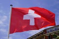 Swiss flag float over blue sky in mat with wind