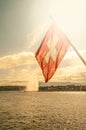 Swiss flag, Leman lake at sunset and a super Jet fountain in the historical downtown of Geneva, Switzerland, summer Royalty Free Stock Photo