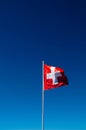Swiss flag - Switzerland flag against bright blue sky