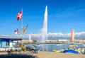 The Swiss flag and the water jet on the Lake Geneva in Geneva, Switzerland Royalty Free Stock Photo