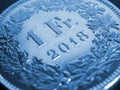 1 Swiss Franc coin close-up. Blue background or wallpaper about economy, business or banking. Money and Central Bank in Royalty Free Stock Photo