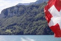 Swiss lakeside landscape with flag of Switzerland