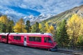 Swiss mountain train Bernina Express crossed Alps in autumn