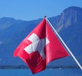 Swiss national flag on landscape of Lake Geneva in Switzerland Royalty Free Stock Photo