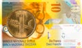 1 swiss rappen coin against 10 swiss franc bank note Royalty Free Stock Photo