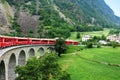 Swiss Red Train Bernina Express pass on Brusio Viaduct, Italy & Switzerland