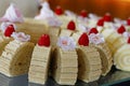 Swiss roll cake slices decorated with berries and edible flowers Royalty Free Stock Photo