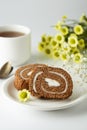 Swiss roll chocolate cake chocolate with cream. Dessert. Breakfast coffee cup and cake. Light background Royalty Free Stock Photo