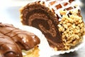 Swiss roll with nuts and chocolate and two eclairs