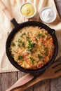 Swiss rosti with herbs close-up in a frying pan. Vertical top vi