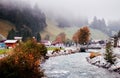 Swiss rural scene with stream and autumn tree in Engelberg, Switzerland