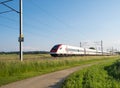 Swiss tilting train SBB ICN RABDe 500 passing through countryside Royalty Free Stock Photo