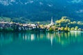 Swiss village Lungern on lake Lungerersee with traditional houses and old church Royalty Free Stock Photo