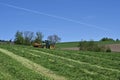 In the Swiss village of Urdorf, a green tractor fitted with a grass-cutting mechanism. Royalty Free Stock Photo