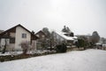 Swiss village Urdorf in winter under snow. Rooftops of the houses are covered with layer of snow.