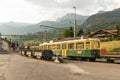 Swiss vintage railway carriage in Grindelwald. Bright yellow and green color. Carriage with door and windows.