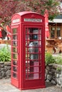 Swisscom public phone in classic red telephone booth Royalty Free Stock Photo