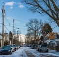 Swissvale, Pennsylvania, USA January 14, 2024 Cars parked on either side of a partially snow-covered street