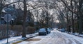 Swissvale, Pennsylvania, USA January 14, 2024 Cars parked on either side of a partially snow-covered street