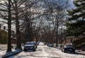 Swissvale, Pennsylvania, USA January 14, 2024 Cars parked on either side of a partially snow-covered street