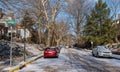 Swissvale, Pennsylvania, USA January 14, 2024 Cars parked on either side of a partially snow-covered street