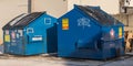 Swissvale, Pennsylvania, USA January 21, 2024 Two blue garbage dumpsters with graffiti on them