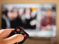 Switch channel in television with remote control Royalty Free Stock Photo