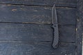 Switchblade knife. Black knife on a black background.