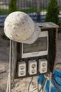 A switchboard on a construction site with sockets and an old work helmet hanging from it. Providing electricity to the Royalty Free Stock Photo