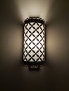Switched on vintage sconce on a dark wall