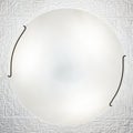 Switched on white round ceiling lamp on white texturized ceiling