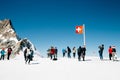 Swiss flag and tourist people on Jungfrau snowy mountain summit in Switzerland